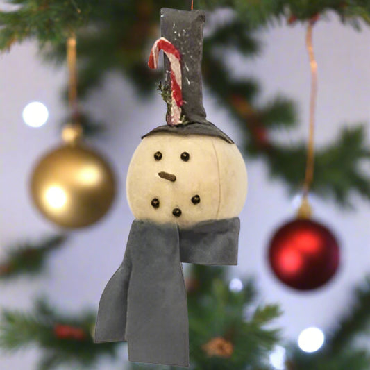 Plush snowman head ornament with a gray scarf and a tall gray top hat with a chenille candy cane and glitter, hanging on a fabric string.