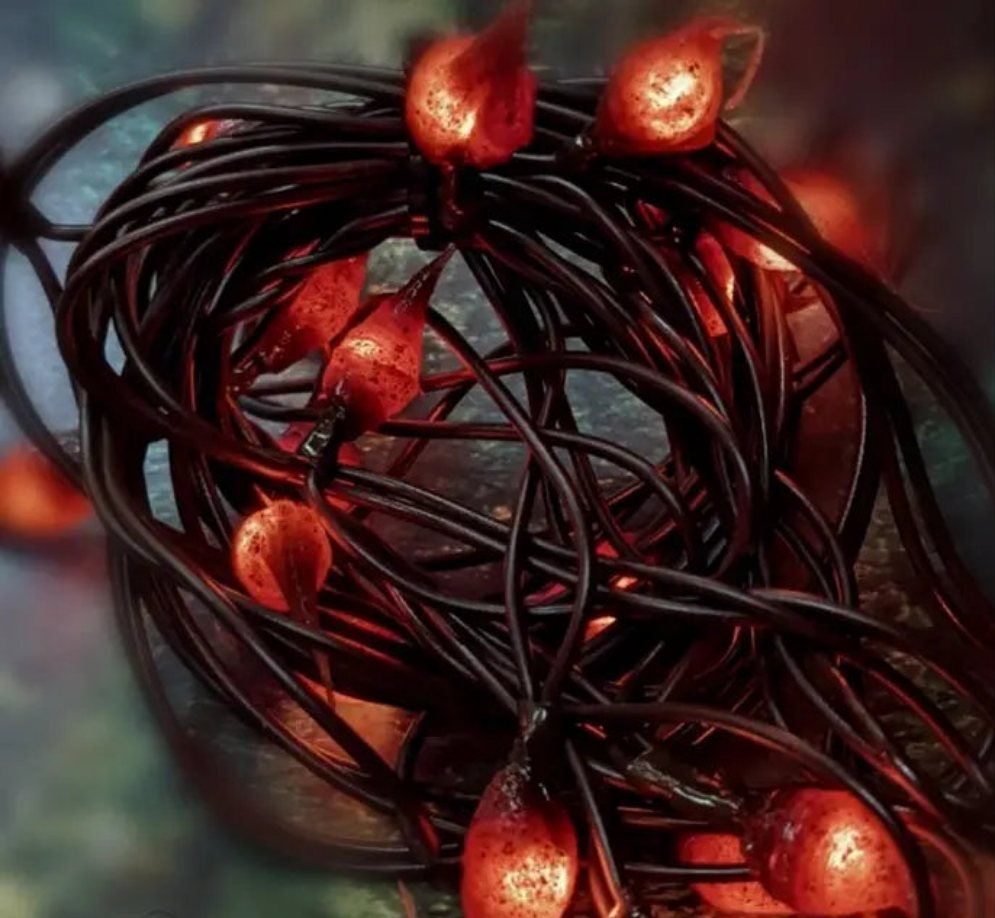 A close-up of a handmade silicone string light with several bulb-shaped light units, creating a warm glow.