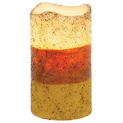 Layered candle with red and yellow colors on a white background