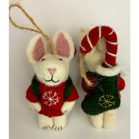 Front and black of felted wool ornament, one in the shape of a Christmas bunny with a stocking backpack, and another resembling a candy cane. Decorated in red, green, and white colors with holiday motifs.