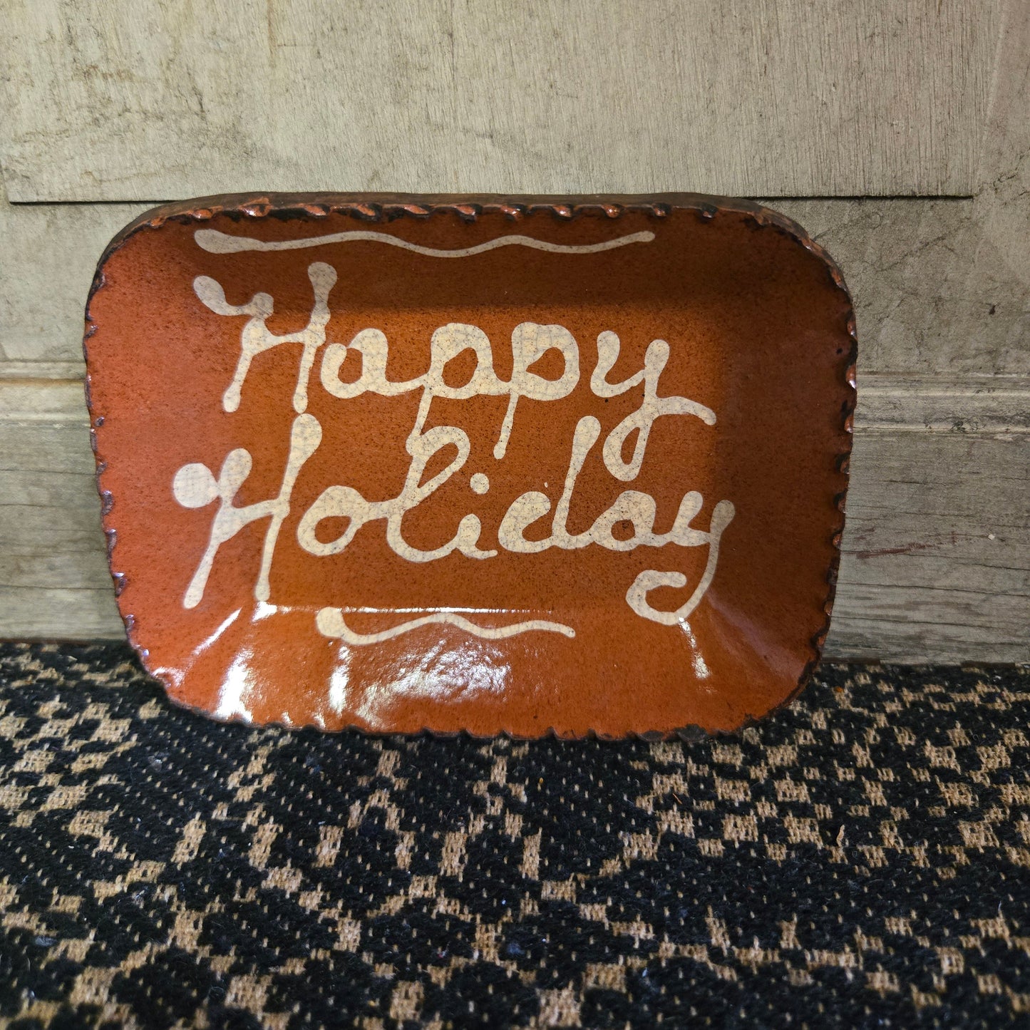 Small rectangular redware plate with the words 'Happy Holiday'