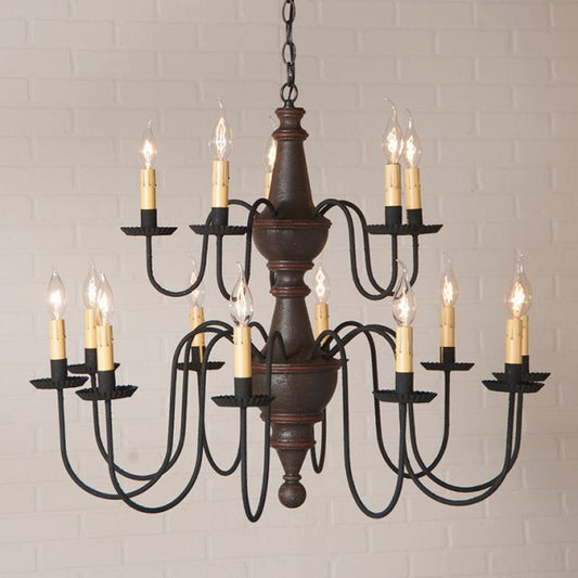 Vintage-style chandelier with multiple candle-like lights against a light brick wall.