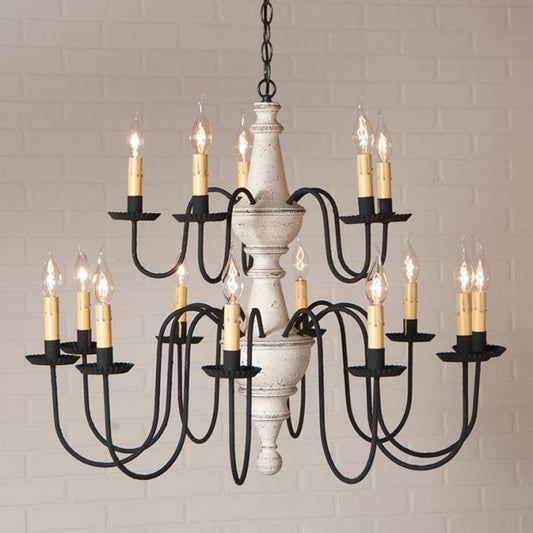 Chandelier with multiple candle-style lights against a brick wall background