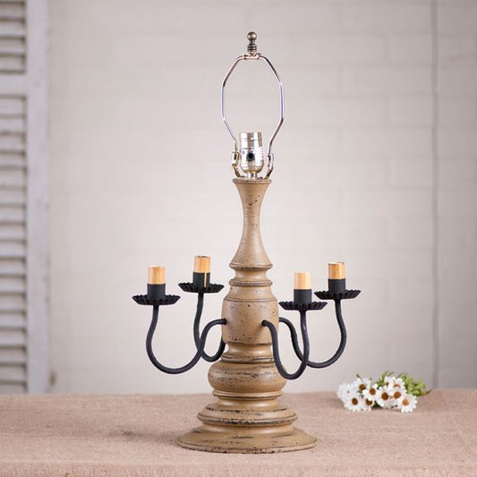 Wooden table lamp with four sockets with pearwood paint finish on white background