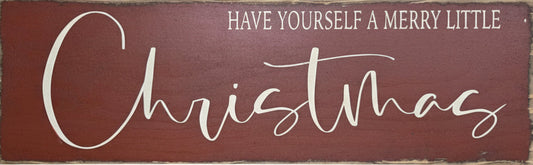 Wooden sign with 'Have Yourself a Merry Little Christmas' text on a red background