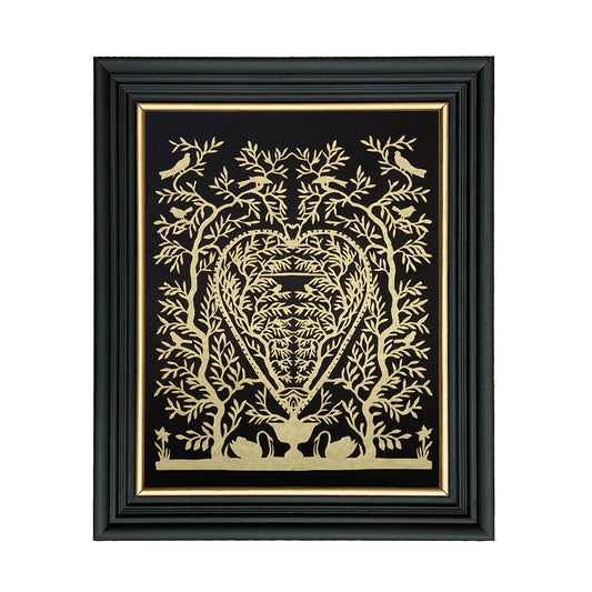 A framed paper cutting artwork featuring a heart-shaped design with swans and trees in gold on a black background, placed against a black frame with a glass cover.