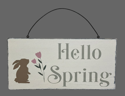 Wooden sign with 'Hello Spring' text and bunny and flower illustrations.