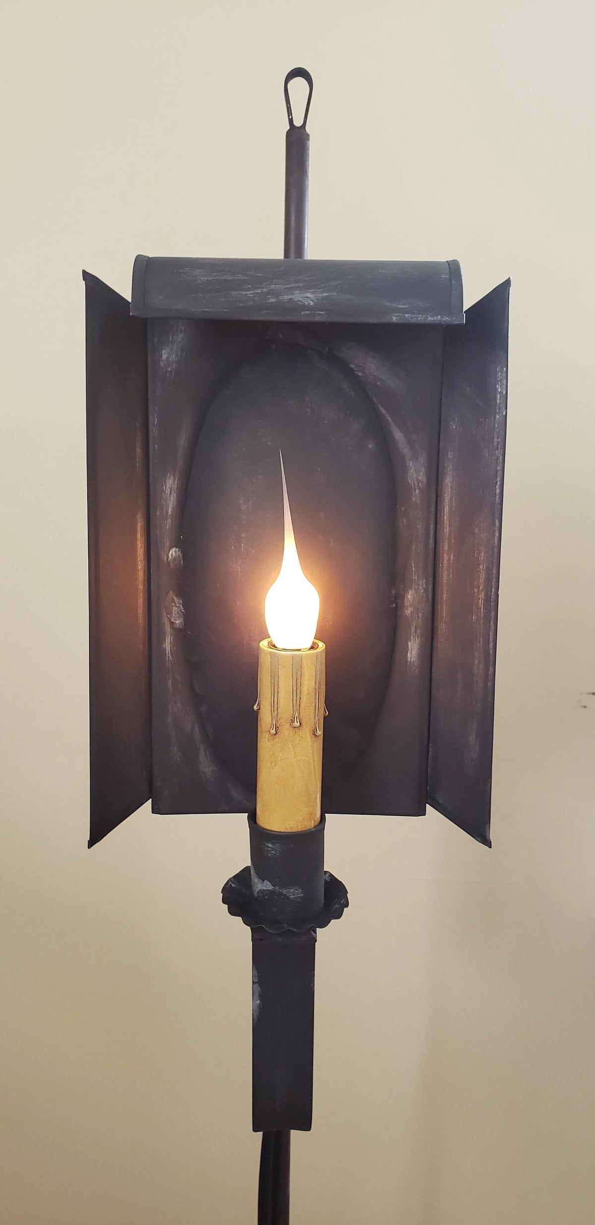 Close up view of tin lamp with one candle sleeve and silicone bulb.