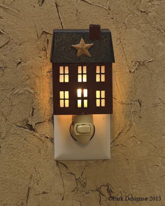 A house-shaped night light that emits a warm glow, mounted on a wall with a textured background.