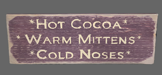 Weathered red wood sign with words advertising hot cocoa