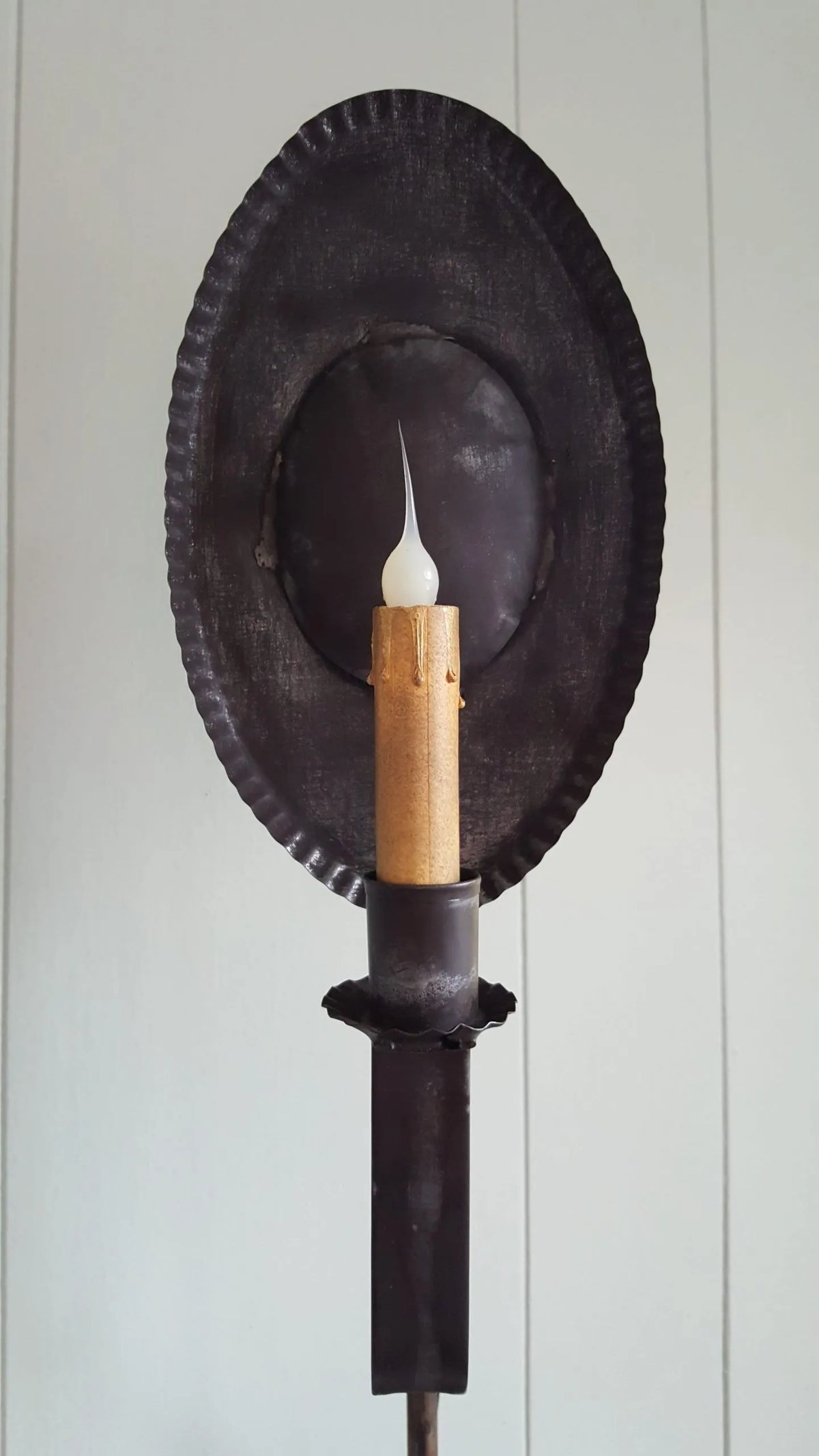 Close up view of tin table lamp with crimped reflector.