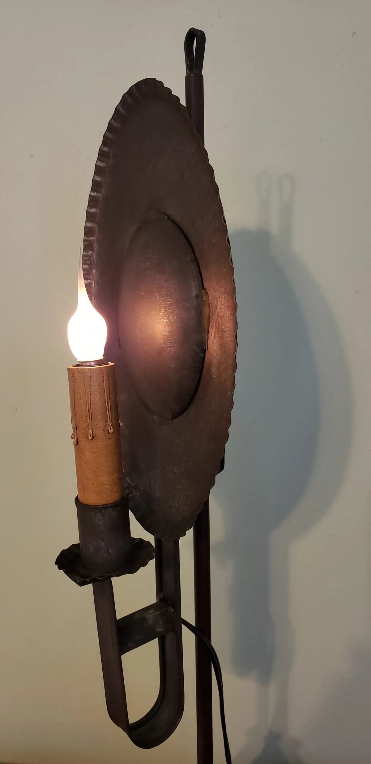 Side view of tin table lamp with crimped reflector.