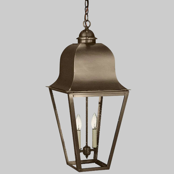 Bronze hanging lantern with two candle-like lights on a gray background