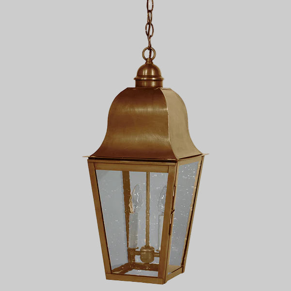 Bronze hanging lantern with glass panels on a gray background