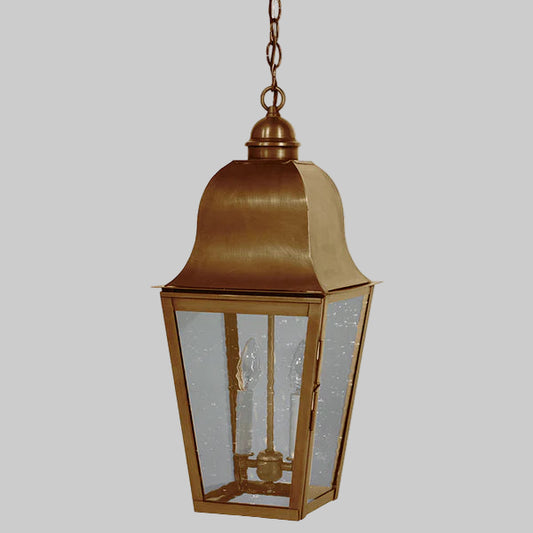 Bronze hanging lantern with glass panels on a gray background