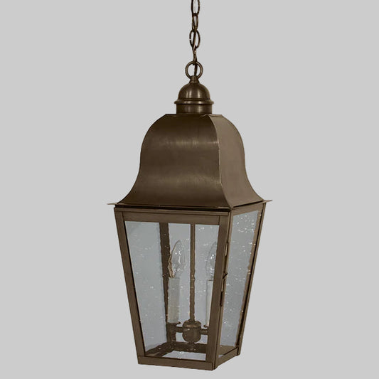 Bronze outdoor hanging lantern with glass panels on a gray background