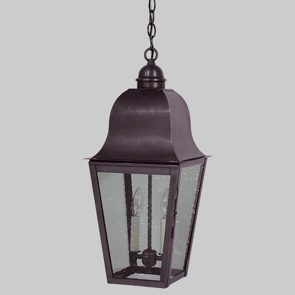 Decorative outdoor hanging lantern with glass panels on a gray background