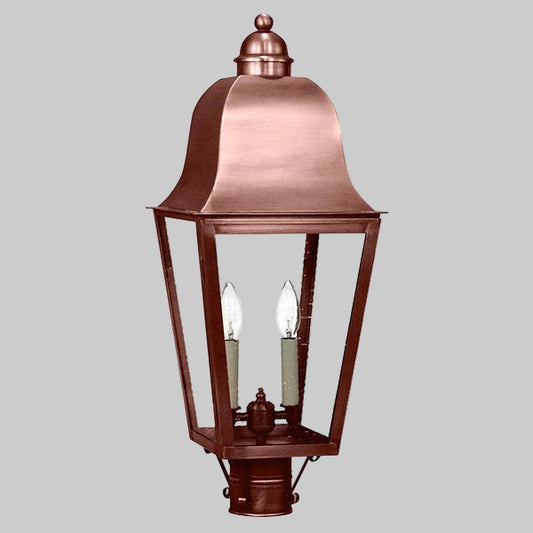 Copper outdoor lantern with two light bulbs on a gray background