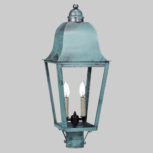 Vintage-style outdoor lamp with a metallic finish on a gray background