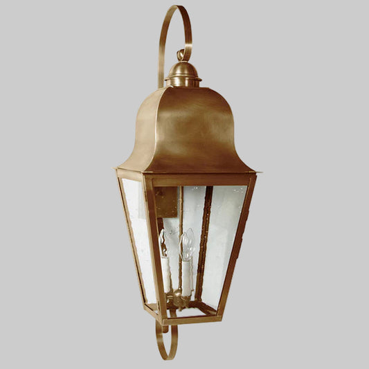 Bronze outdoor wall lantern with clear glass on a gray background