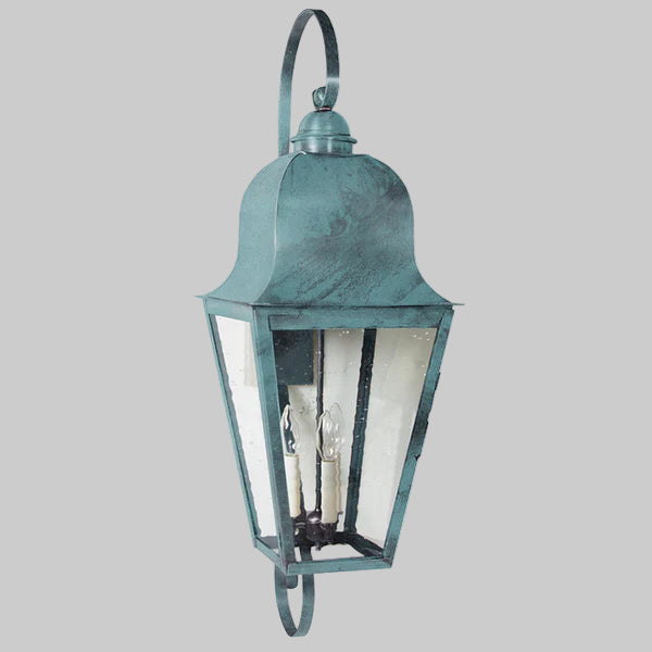 Vintage-style outdoor wall light fixture with a teal finish on a gray background