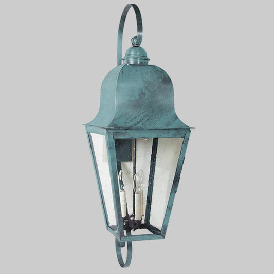 Vintage-style outdoor wall light fixture with a teal finish on a gray background