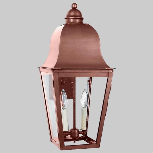 Copper outdoor wall light fixture on a gray background