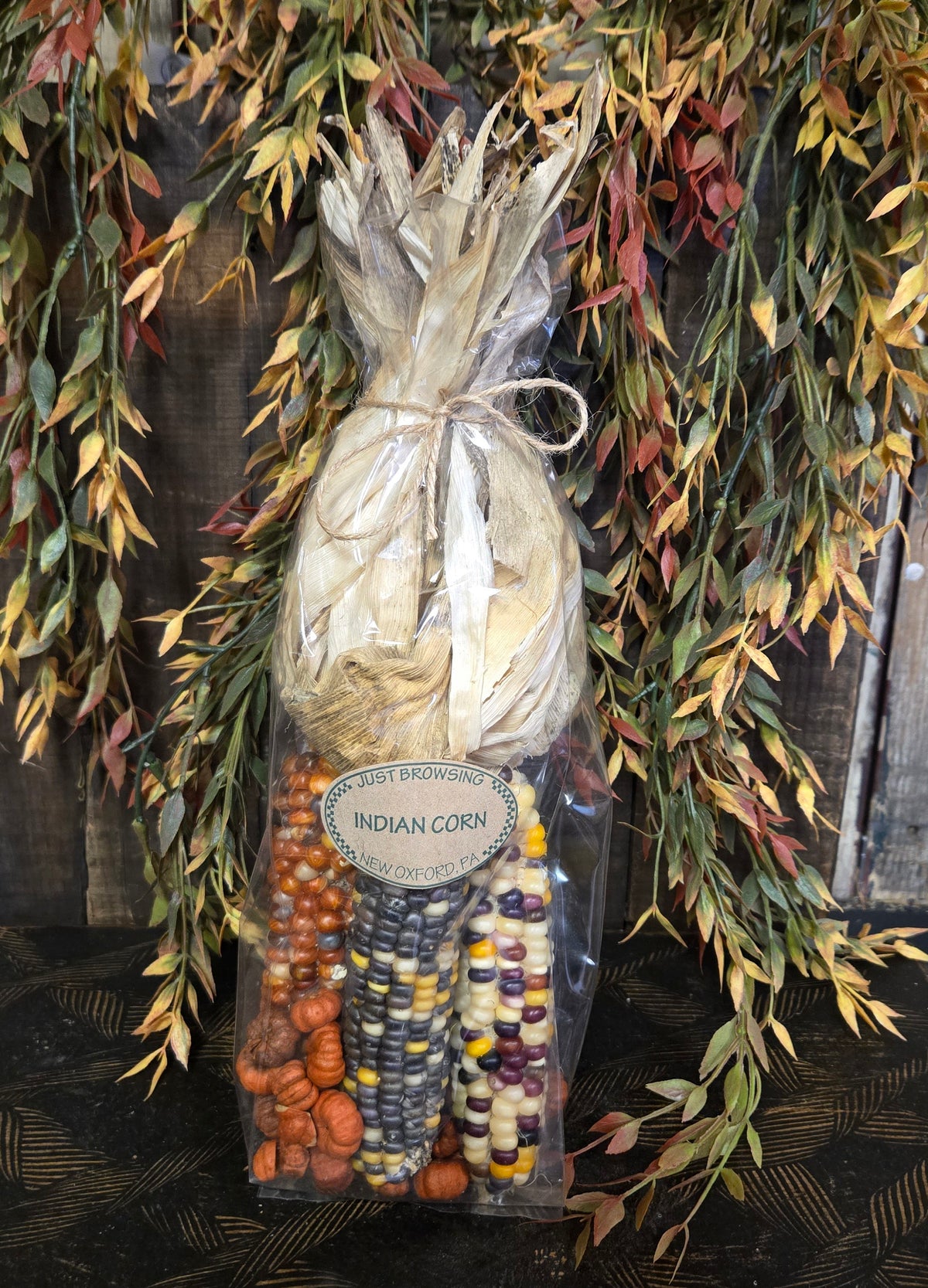 Bag of dried corn with a label on a decorative background
