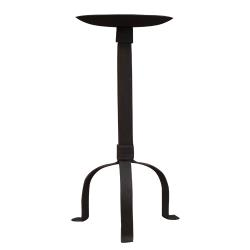 A black iron pillar holder with three legs and a round candle dish at the top