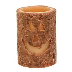 Battery operated candle with a jack-o-lantern carved into the face.