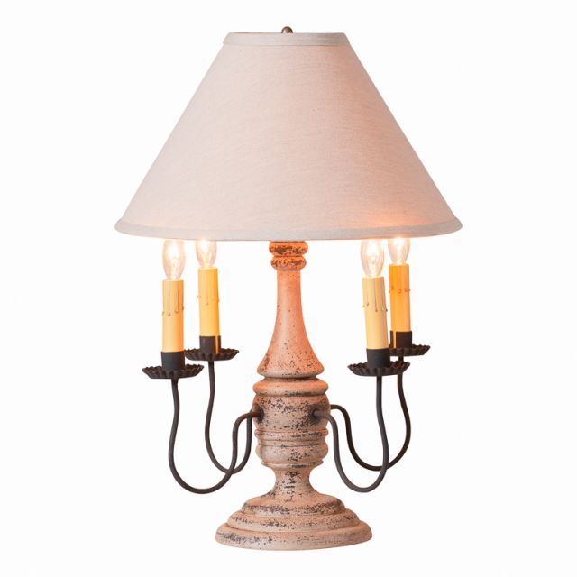 Decorative table lamp with a textured base and white shade on a white background