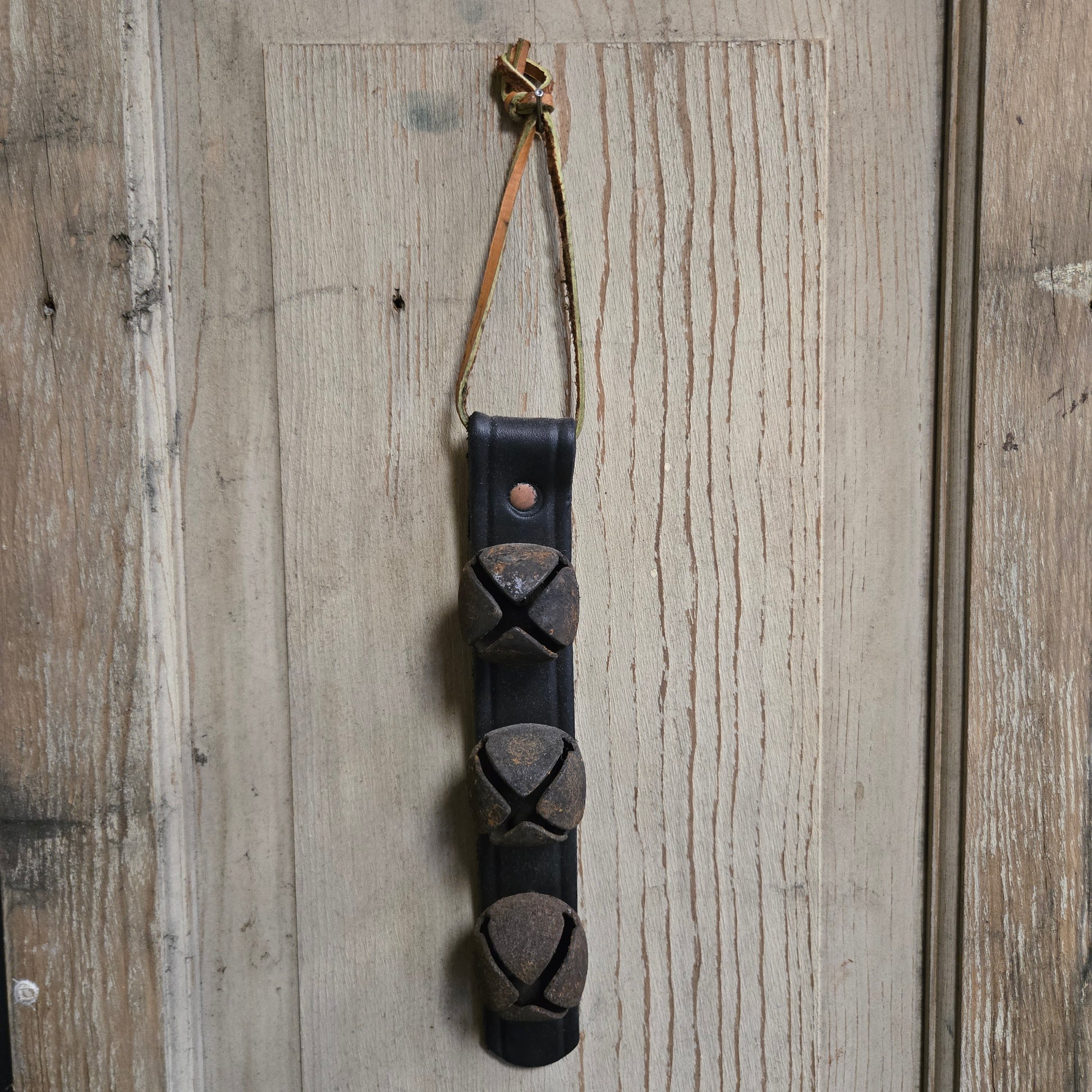 Decorative leather strap with metal accents on a wooden surface