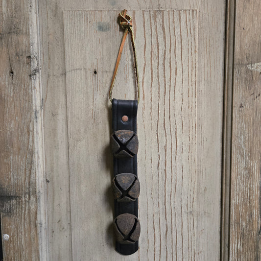Decorative leather strap with metal accents on a wooden surface