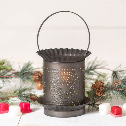 Decorative metal lantern with star design on a white background with Christmas decorations.