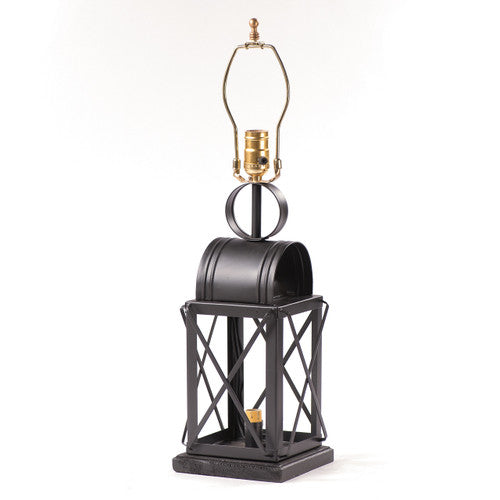 A black metal lantern table lamp with a brass-colored arched neck and socket, set against a plain white background.