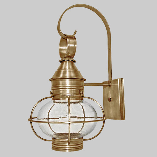 Brass outdoor wall light fixture with glass shade on a white background