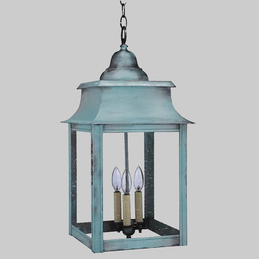 Blue hanging lantern with three candle-like lights on a white background