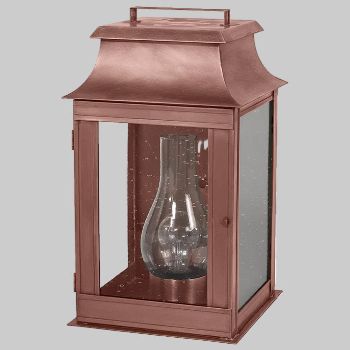 Copper lantern with glass shade on a white background