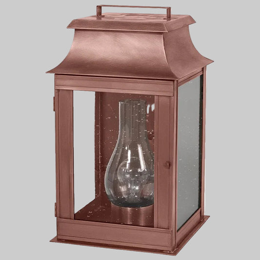 Copper lantern with glass shade on a white background