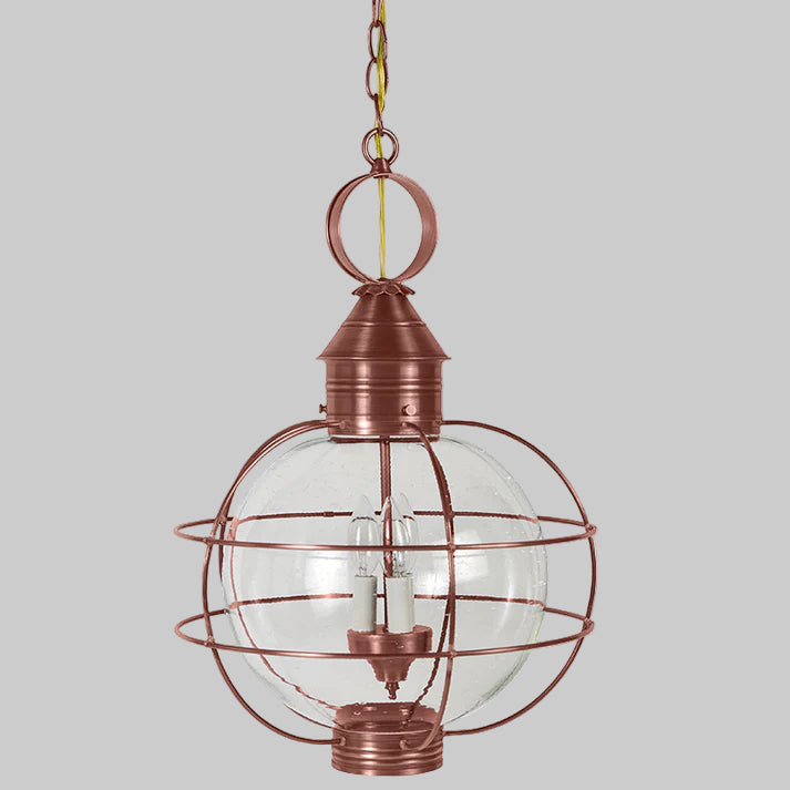 Copper pendant light with clear glass shade on a white background