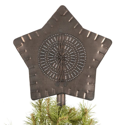 A Kettle Black finish star-shaped tree topper made of metal, displayed atop a pine tree.