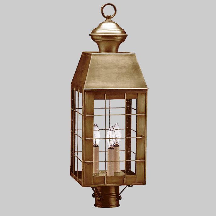 Bronze outdoor lantern with glass panels on a white background
