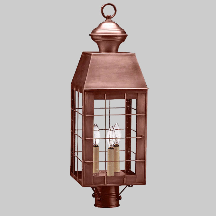 Copper outdoor lantern with glass panels on a white background