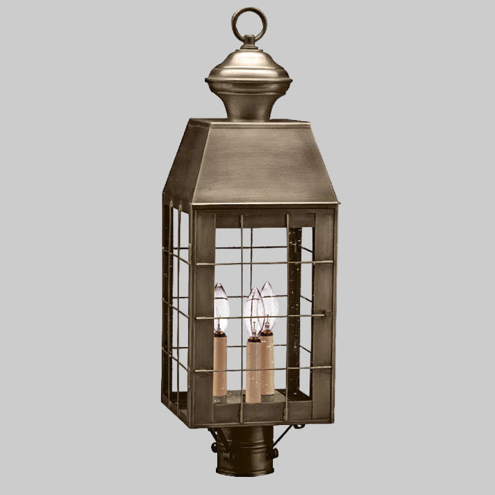 Bronze outdoor lantern with glass panels on a white background
