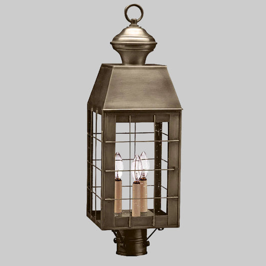 Bronze outdoor lantern with glass panels on a white background