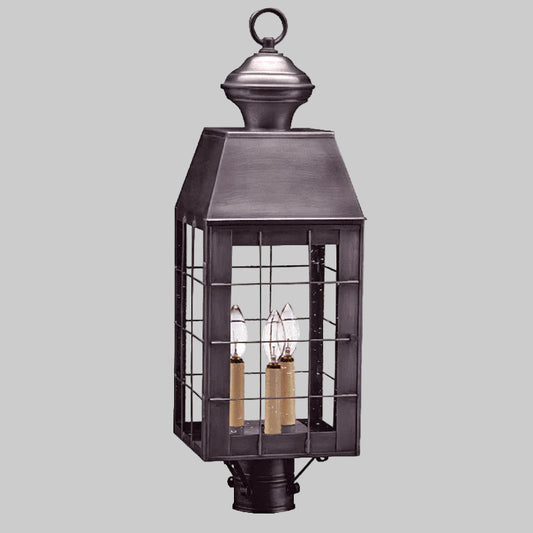 Decorative outdoor lantern with metal cage on a white background