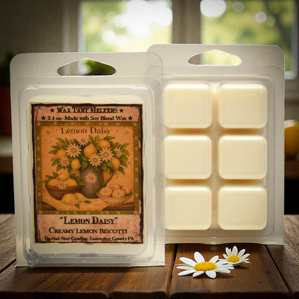 Wax tart melt package with 'Lemon Daisy' design on a wooden surface.