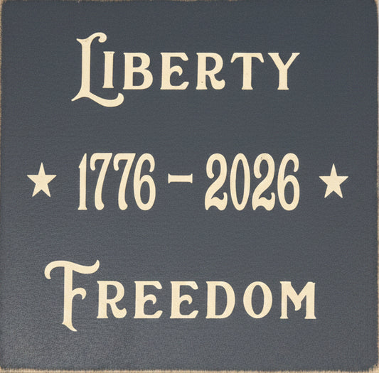 Navy blue sign with 'Liberty 1776-2026 Freedom' text in beige.