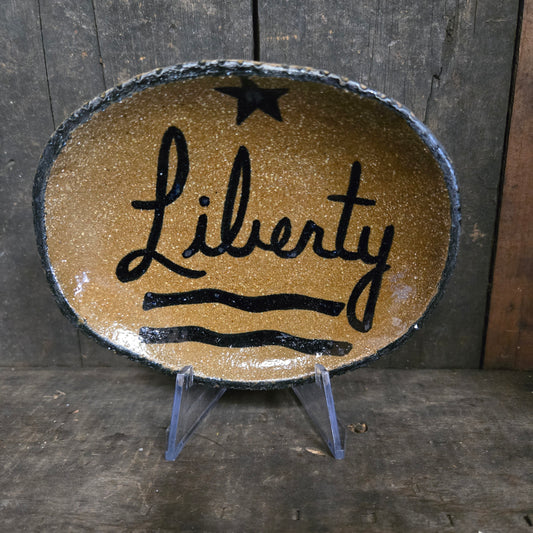 Oval dish with 'Liberty' text on a wooden background