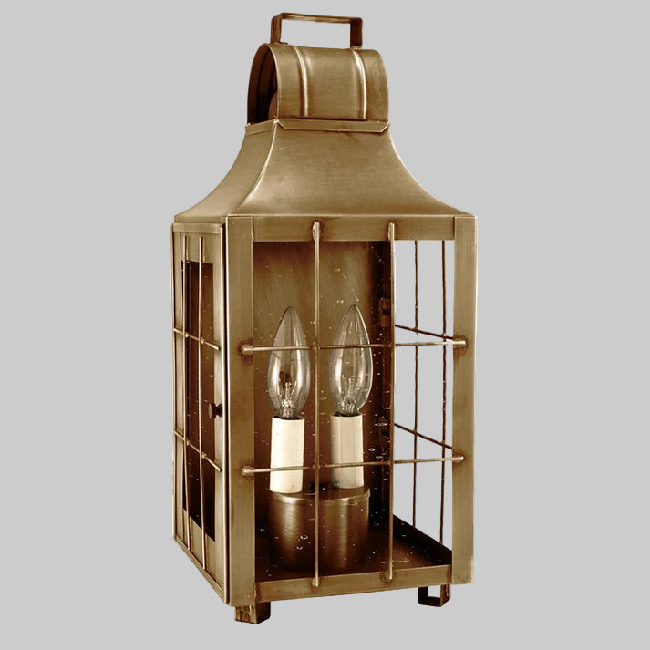 Brass lantern with two clear glass bulbs on a white background